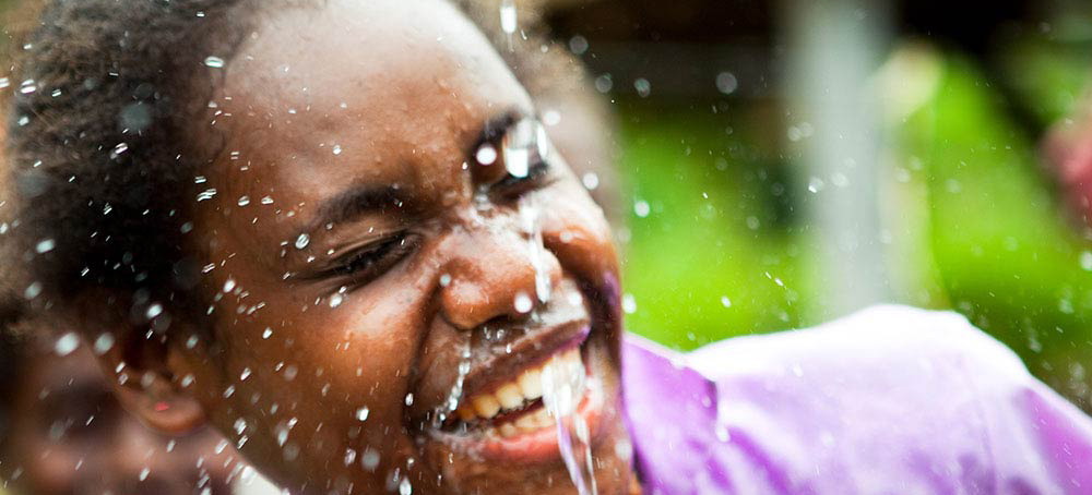 A group of children drinking water from cups